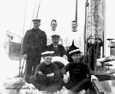 Crew of Eileen
The crew of Eileen, a 75ft ketch built by William Fife in 1930, from the then Royal Northern Yacht Club at Rhu. Image supplied by Liz Sutherland, whose grandfather, Helensburgh man John Macdonald, worked as a steward on various yachts in the 1930s and later as a catering manager at several golf clubs in the West of Scotland. Names would be welcomed.

