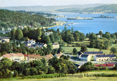 Mothballed warships
Garelochhead and the Gareloch from Whistlefield Brae, showing mothballed Royal Navy warships lying at anchor in the loch — a ship of the King George V battleship class in the foreground and two others of the class in the background. The first of these ships was laid up there after decommissioning in November 1949, followed by King George V (June 1950) and Duke of York (November 1951). Approval for scrapping these ships was given in April 1957, so the image date is likely to be between 1951 and 1957.
