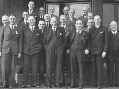 Pro for 50 Years
A party at Helensburgh Golf Club in 1945 to celebrate Tom Turnbull retiring after completing 50 years as the club professional. From left, back: Messrs McCulloch, Aitkenhead, Easton, Keir, Davidson; third row: Messrs McAuley, Clements, Herbeson, Spy; second row: Messrs Michie, McAuslan, Jack, Douglas; front: Messrs Colville, Rafferty, Workman, Downs, Fairbairn with Tom Turnbull in the centre. Image supplied by Iain McCulloch.
