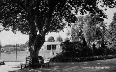 Hermitage Park
The tree seat in Hermitage Park, Helensburgh, with two tennis courts and the now replaced pavilion beyond. Image date unknown.
