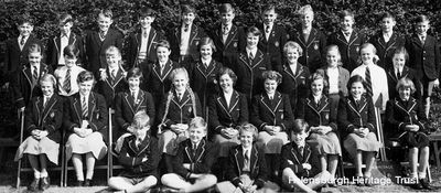 Hermitage Secondary 1B 1956
Back row: Colin McCallum, X, Ian McAulay, X, Jim Jack, X, X, David Galloway, X, Alastair McIntyre, X; 2nd back row: Irene McLaren, X, X, Helen Murdoch, X, X, Janet Fagan, Jean Crook, X, X; 2nd front row: X, X, Lindsay Malan,X, X, X, X, X, X; front row: Jim Graham, Andrew Watt, X, Robert Cameron. Image supplied by Jim Graham. More names would be welcomed.
