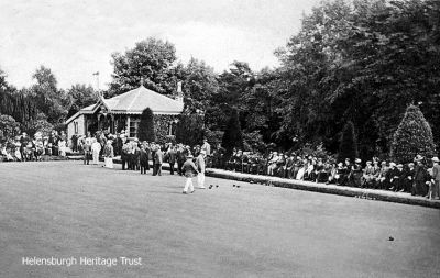 High Green
A 1913 image of players and spectators at Helensburgh Bowling Club â€” known as the High Green, as opposed to the former Low Green at Hermitage Park â€” with the old pavilion in the south east corner.
