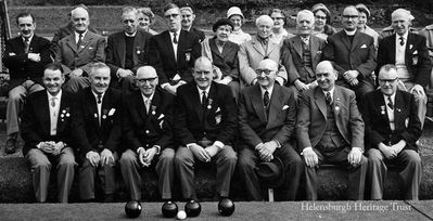 High Green centenary
The president and directors of Helensburgh Bowling Club and guests celebrate the High Green club's centenary in May 1961. Fourth from the right in the middle row is the honorary president, J.Arnold Fleming. Others in the picture include Willie Cowe, Alex Douglas, Richard Don, and the Rev Dr George Logan of Park Church.
