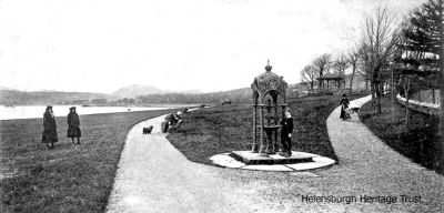 Ornate fountain
A young boy poses beside an ornate drinking fountain which used to stand in Helensburgh's Kidston park. Image c.1903.
