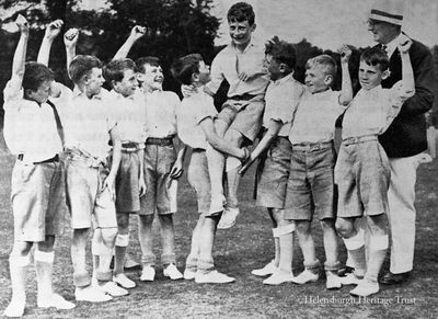 Salute to champion
Fellow competitors at the annual Larchfield School Sports Day in June 1935 and a teacher salute the champion.
