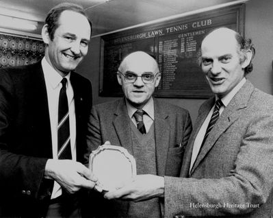 First winner
Helensburgh Lawn Tennis Club president Duncan Robson (right) and vice-president Donald Fullarton (left) present the Winifred McKenzie Salver to first winner Alec Forsyth. The salver was won by Mrs McKenzie at the club's golden jubilee celebrations, and at the centenary celebrations in 1984 she presented it to the club. The committee decided that it should be presented annually to someone who had given distinguished service to the club, on or off court.
