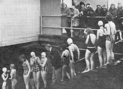 New Year Swim 1966
By tradition, girls were the first to enter the water at Helensburgh pier. The first man in was Helensburgh Swimming Club president Angus Trail, his 38th Ne'erday plunge. This was the first year that certificates were presented to the participants. Designed by local artist Gregor Ian Smith, they bore the proud inscription 'Many are cauld but few are frozen'.
