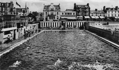 Backstroke race
Three contestants are seen battling it out in a Helensburgh Swimming Club backstroke race at the outdoor pool in this 1949 image. Built in 1928 as a gift from Provost Andrew Buchanan, beside the pier, the pool was replaced in 1976 by an indoor pool on an adjacent site, and a year later the outdoor pool was closed. It was demolished in 1996 and replaced by a childrens play area.
