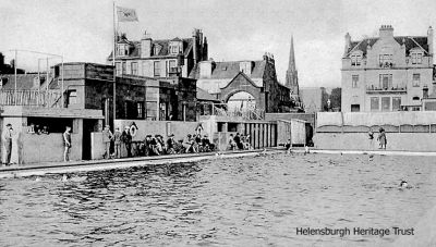 Outdoor pool
Built in 1928 as a gift from Provost Andrew Buchanan, beside the pier, the Helensburgh outdoor swimming pool was replaced in 1976 by an indoor pool on an adjacent site, and a year later the outdoor pool was closed. It was demolished in 1996 and replaced by a childrens play area. Image date unknown.
