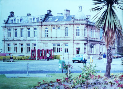 The Post Office
Looking across Colquhoun Square from the north east quadrant â€” which has a palm tree in its flowerbed â€” towards the Post Office. Image circa 1970.
