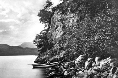 Rob Roy's Cave
The entrance to Rob Roy's Cave on Loch Lomond, circa 1915. It is sited on the east bank near Inversnaid and was not so much a cave as a shelter provided by the fallen rocks. It is thought to have provided shelter for both Rob Roy and Robert the Bruce — the latter is said to have been saved from his pursuers when sleeping wild goats in front of the cave misled his enemies into believing it was empty. Rob Roy was for a time Laird of Craigrostan and Inversnaid.
