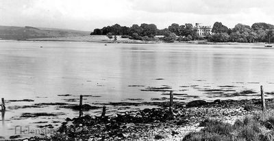 Rosneath Castle
A view of Rosneath Castle from across the bay at Clynder, circa 1960. Completed in 1806 by London-based architect Joseph Bonomi, this neo-classical mansion replaced a castle burnt down in 1802. It was used as a military hospital during the First World War and was home to Queen Victoria's daughter Princess Louise, the Dowager Duchess of Argyll, until her death in 1939. It was an HQ for the Rosneath Naval Base in World War Two, then abandoned, then damaged by fire in 1947, and demolished in 1961.
