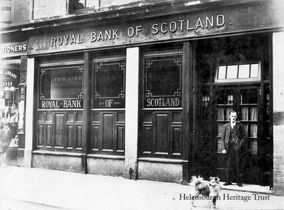 Royal Bank
The exterior of the Royal Bank of Scotland branch in East Princes Street, next to stationers Macneur and Bryden Ltd. The picture was taken by Wilson Brothers Photographers, of Glasgow, and in front is manager John R.Dixon, circa 1936. Image supplied by Marion Gillies.
