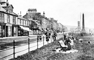 Seafront with rails
A traditional view of Helensburgh seafront looking east towards the Henry Bell monument, the bandstand beyond, and the Old Parish Church, taken when there were still railings between the pavement and the grass, and published by M.C.Robertson, West End Library, Helensburgh, circa 1906.

