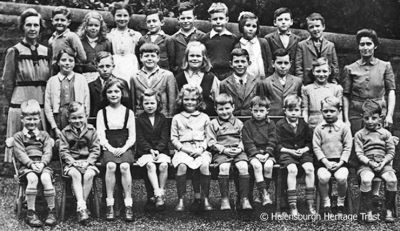 Shandon School c.1944
Elinor Grummitt, who still lives in Shandon, supplied this image from around 1944. She is second left, back row. Her sister is middle of the  middle row and her brother second left, front row. Far left is teacher Miss Buchanan, who came after Miss Willan retired, and the lady on the right is Mrs Hutchison, who helped out her janitor husband. The boy, second right bottom row, was Polish. His father was an officer in the Polish army, billeted at Shandon Hydro. His name was Richard Stetner.
