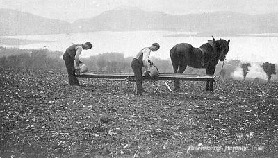 Sowing corn
Two farm workers prepare to sow corn on the hillside above Loch Lomond. Image circa 1906.

