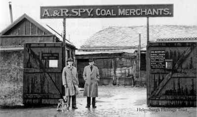 Spy's Coalyard
A. & R.Spy, coal merchants and colliery agents, had a coalyard at 23-25 Sinclair Street â€” in the middle of the block between Clyde and Princes Streets â€” until 1964 when the business was sold to D. & G.Allan Ltd. of Glasgow. It was then acquired by William Low Ltd. who built the town's first supermarket on the site and opened it in 1966. The firm also had premises at 110 West Princes Street and a wholesale depot at Helensburgh Central Station. In the picture, supplied by Pat Drayton, are Robin and Jack Spy.
