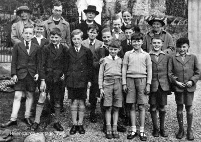 Choir trip
The choir boys of Helensburgh's St Michael and All Angels Church on a trip to Kilcreggan in 1941. Back row: Mrs Baird, ?, the Rev Charles B.Baird, ?, Robert Neil; middle: Robert Livingstone, Robert Hailstones, Tom Paterson, Roy Mackenzie, Robert Wright, Thomas Neil (Robert's brother), Robert Weir Lees; front: ?, ?, ?, ?, ?. The photograph, taken by church organist James P.Whimster, was kindly supplied by Robert Hailstones.
