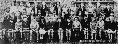 St Joseph's Primary 2 and 3, circa 1958
Back:Christine Cavana, John McCann, Manya Masikevic (?), Peter Cannon, Muriel Cole, Simon Cavana, Kathleen Skea, Evelyn Roach, Tony Graham, Catherine Gallagher, Tommy MacLaughlan, Elizabeth McFarlane, Manus McClafferty; middle: John Harvey, Ian Donnachie, Sally Campbell, Kay Campbell, Anne Savage, Isabel Kiernan, Quentin Hefferman, Mary McClafferty, Charlie Booth, Jessie Grant, Ian Donnachie, Andrew McKenzie, Patricia Evans, Jeanette Sharkey; front: Michael McGinley, Mary Brabender, Hugh Oâ€™Brien, Linda McQueen, John ?, Betty McAndrew, Terence Neil, Graham McKenzie, Ian Mundie, Maisie McCallum, John McLelland, Maureen Reilly, James Brabender, Marion McGunigal, Peter Barnes. Image supplied by the daughter of the late Manus McLafferty, who later became a boat painter at McGruer's Yard at Clynder; names supplied by Patricia Willis (nee Evans).
