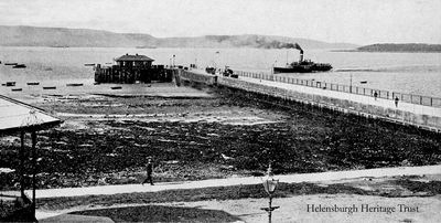 Steamer approaches
A steamer approaches Helensburgh pier, image circa 1928. The following year the outdoor swimming pool was built beside the pier. The image also shows the waiting room and ticket office building on the end of the pier, and on the left, part of the bandstand beside West Clyde Street.
