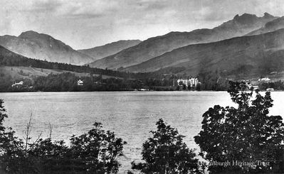 Tarbet and the Cobbler
A view from the eastern side of Loch Lomond looking across at Tarbet, with its large hotel prominent, and beyond to the summit of the Cobbler mountain. Also known as Ben Arthur, it is called the Cobbler because of its resemblance, from a distance, to a cobbler at work. Image circa 1934.
