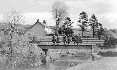Black Bridge, Glen Fruin
A photograph taken in the 1920s by keen amateur photographer Robert Thorburn, a Helensburgh grocery store manager. It shows the Black Bridge in Glen Fruin, with the schoolhouse in the background.
